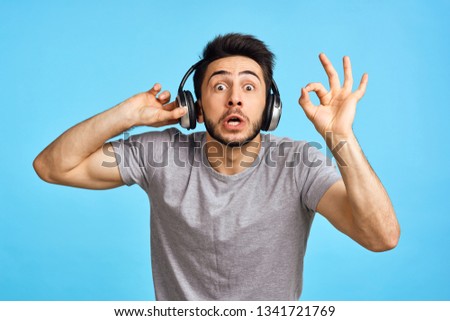   man listening to music with headphones signs                             