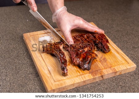 food, delicious and craft concept - Man cutting horse steak