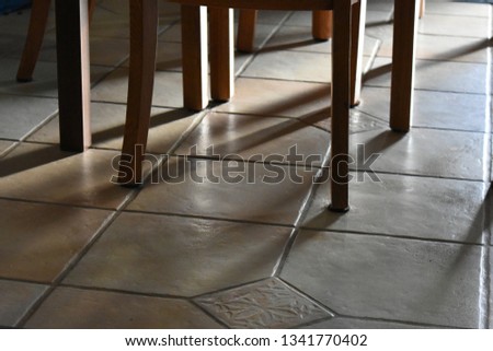 table and chair legs on tile
