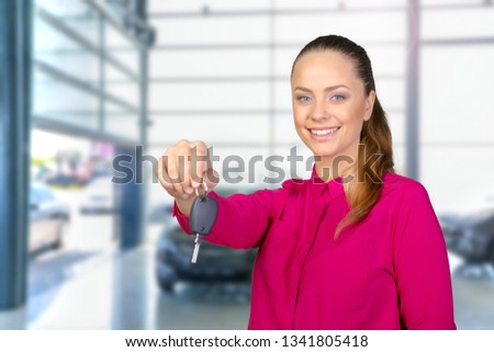 Portrait of happy woman holding a car key