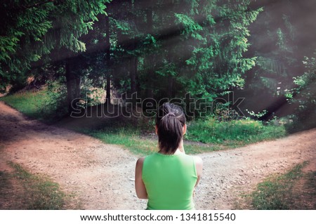 Girl with a choice near the forked road Royalty-Free Stock Photo #1341815540