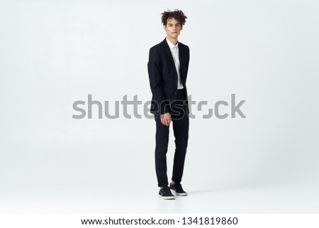 business man in a suit curly hair black sneakers puzzled look            