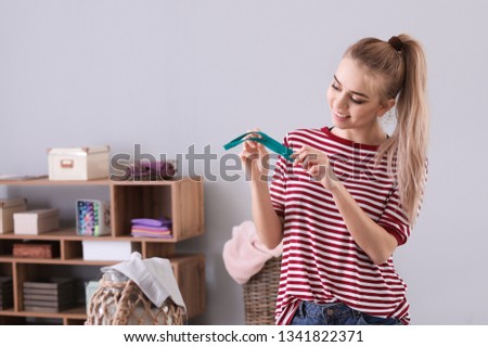 Young woman with zipper at home