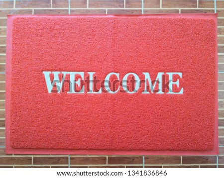 Welcome red mat in front of door, shop 