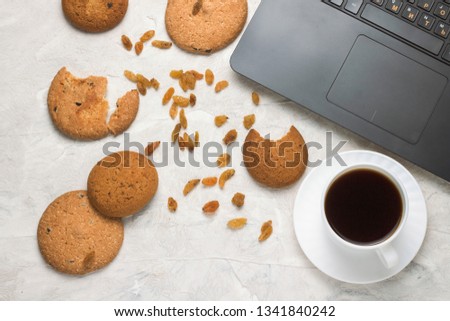Homemade Oatmeal Cookies, Cup of Coffee and Laptop on a Light Stone Background. Student Weekdays