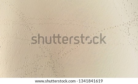 Stunning wide angle aerial drone view of a beautiful red sand dune. Background texture of desert sand dunes from a high angle. Aerial top vertical shot of sandy desert for holiday vacation concept