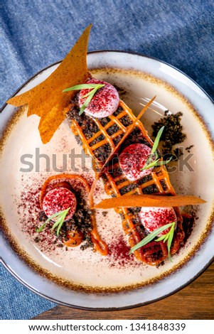 Dessert with chocolate sponge cake and apple pastila. European cuisine. The work of a professional chef. Dish from a restaurant or cafe menu. Close-up.