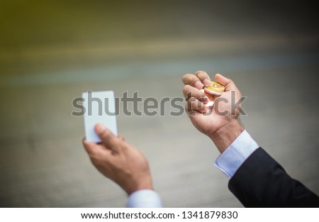 Hand holding golden bitcoin and Smart card - Image 