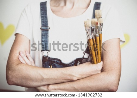 time of creativity. girl painter holds a brush
