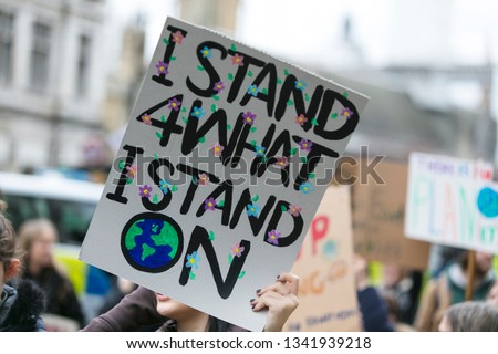 People with banners protest as part of a climate change march