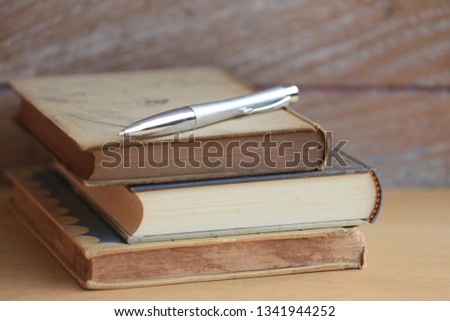 Close-up of old books stacked Old wooden floor as background selective focus and shallow depth of field