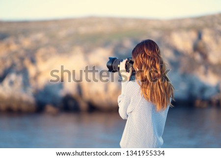 Woman photographer in nature takes pictures