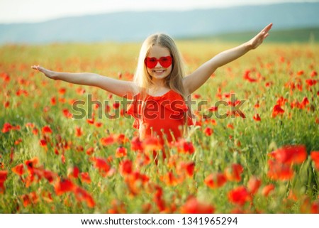 Child in a field with flowers