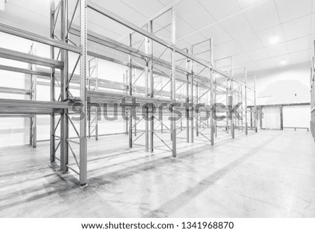 monochrome Interior of empty warehouse with empty racks 