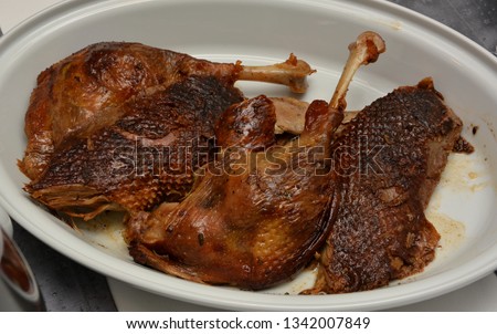 Appetizing roasted Christmas goose (goose legs and goose breast) Royalty-Free Stock Photo #1342007849