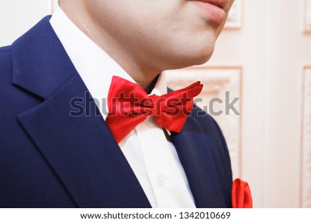 groom in a chic costume with stylish accessories is going to the wedding. Watch, boutonniere, shoes, bow tie