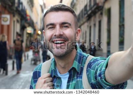 Handsome man taking a selfie outdoors 