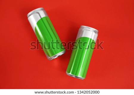 Blank metal cans on color background, flat lay. Mock up for design 