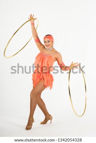 A charming girl performs circus elements with a hula Hoop. Studio shooting on a white background, isolated image.
