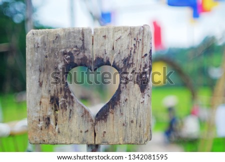 wooden heart on blurred colorful cloth lamp in a beautiful day