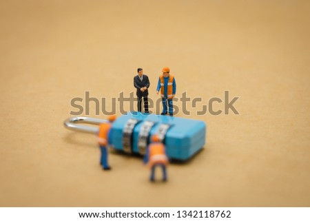 Miniature people Construction worker Security Key Repair And the treatment of the precious. on white background using as background business concept and Security concept with copy space. 