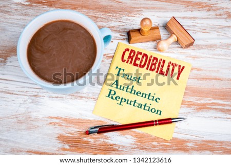 CREDIBILITY concept. Text on a napkin with a cup of coffee 