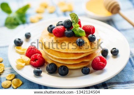 Pancake Blueberry Fried Dessert Stack Breakfast. Golden Sweet Crepe with Raspberry for Tasty Shrovetide Brunch. Hotcake Syrup Product on Tablecloth with Berry and Banana Mardi Gras Morning Lunch Royalty-Free Stock Photo #1342124504