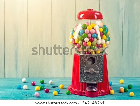 Carousel Gumball Machine Bank on a wooden background Royalty-Free Stock Photo #1342148261