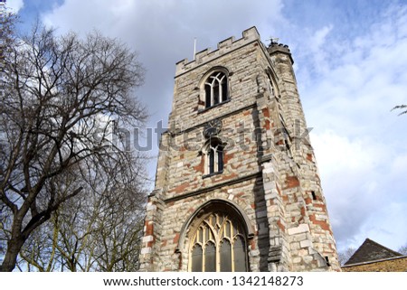 The beautiful West Ham Parish Church (All Saints Church) is a parish church in Stratford, E15, in east London. It has been a Grade I listed building since 1984. The images contain trees and blue sky. 