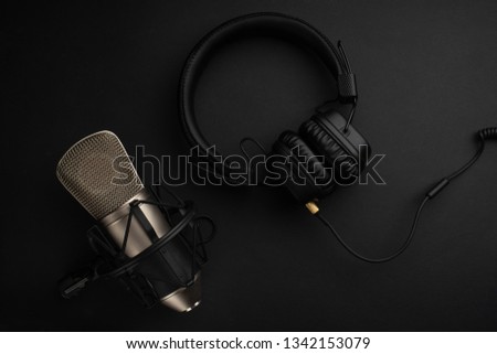 Studio microphone with headphones on a yellow background. Flat lay. Design. Radio and music. Stylish background