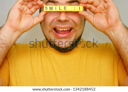 no eyes. unrecognizable person. Many fingers Holding the Word - smile. isolated on gray Background. happy face