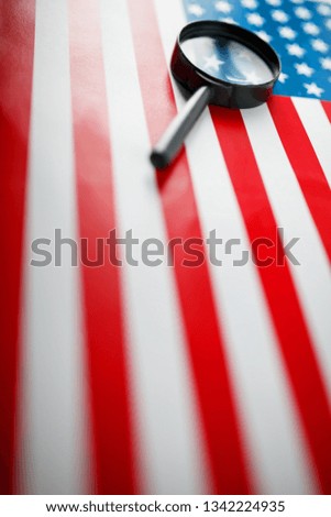 US flag looking through a magnifying glass. Study of the history and culture of the country of the United States. The concept of studying geography, English and customs