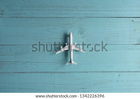 Miniature toy airplane on wooden  background. Trip by airplane.