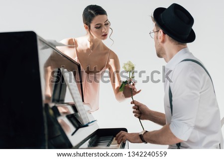 handsome musician gifting rose to beautiful ballerina 