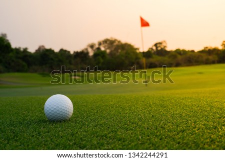 A long putt on green as sunset closes in