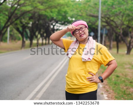 Overweight woman feeling tired while running in the park.Weight loss concept Royalty-Free Stock Photo #1342253678
