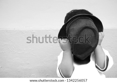 Close up portrait of Baby boy,young kids taking off his hat to close his face.                  