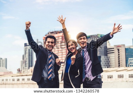 Happy businessmen and businesswoman celebrate success in project task achievement. Concept of business winner and victory.