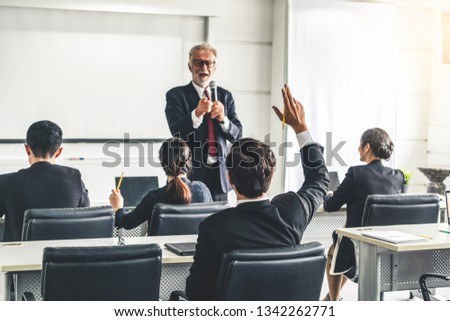 Senior leader speaker speaks to public people audience in training workshop or conference. Mature lecturer is CEO executive manager leading the symposium event. International business seminar concept.