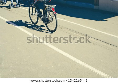 concept of outdoor activities - cyclist, child on gyro board, pedestrian