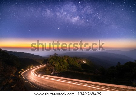 Milky Way Galaxy with lighting on the road and layer of mountain at Doi inthanon Chiang mai, Thailand
