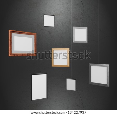 Group of photo frames hanging on twine.