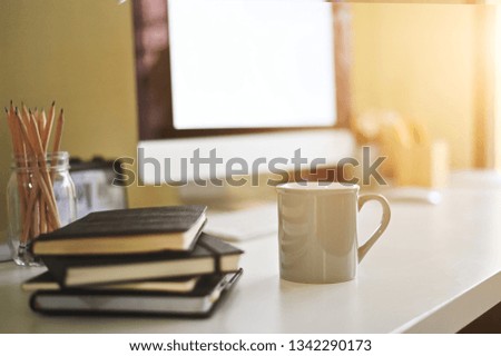 Mug of coffee on creative desk.