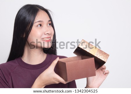 Young Asian woman open a gift box on white background