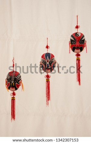 Three Chinese masks with white background in line
