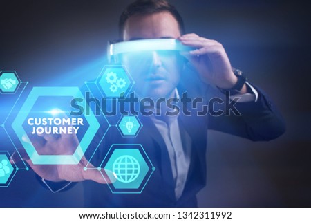 Business, Technology, Internet and network concept. Young businessman working in virtual reality glasses sees the inscription: Customer journey