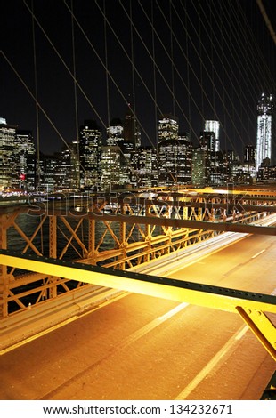 Night traffic in the brooklyn bridge with a skyline of New York