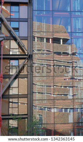 Abstract image of Tate Modern, London Reflected in glass windows of adjacent building. Reflection is distorted with interesting colours and angles.