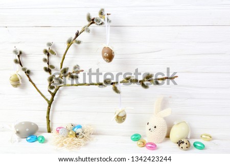 Easter eggs, rabbit and  catkins on a wooden background