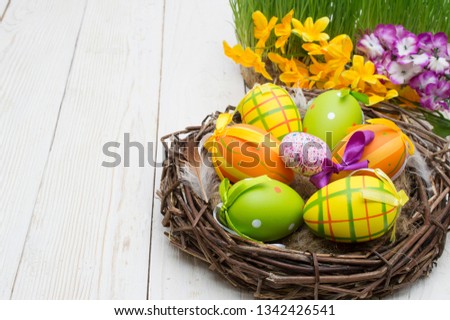 Easter decoration with eggs on a wooden background. Royalty-Free Stock Photo #1342426541